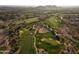 Scenic aerial view of a meticulously maintained golf course nestled within a beautiful desert landscape at 8057 E Greythorn Dr, Gold Canyon, AZ 85118