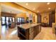 Large kitchen island with granite countertops, stainless dishwasher, and custom cabinets at 8057 E Greythorn Dr, Gold Canyon, AZ 85118