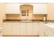 This laundry room features white cabinets, granite countertops, a sink, and a white washer and dryer at 8057 E Greythorn Dr, Gold Canyon, AZ 85118