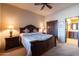 Comfortable bedroom with a ceiling fan, nightstands with lamps, and a king-size bed at 8057 E Greythorn Dr, Gold Canyon, AZ 85118