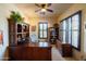 Well-lit home office featuring custom wood desk, bookshelves, and shutters for privacy at 8057 E Greythorn Dr, Gold Canyon, AZ 85118
