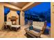 Cozy covered patio with a fireplace, comfortable seating, and a grill, perfect for relaxing and entertaining by the pool at 8057 E Greythorn Dr, Gold Canyon, AZ 85118