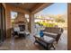 Comfortable outdoor living area with plush seating, fireplace, and built-in grill for relaxation and entertainment at 8057 E Greythorn Dr, Gold Canyon, AZ 85118