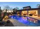 Resort-style backyard with a beautiful pool, spa, and desert landscaping, perfect for relaxing and entertaining at 8057 E Greythorn Dr, Gold Canyon, AZ 85118