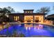 Stunning backyard featuring a sparkling pool, spa with a waterfall, and an outdoor dining and lounging area at 8057 E Greythorn Dr, Gold Canyon, AZ 85118