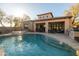 The pool features a rock waterfall from the jacuzzi and a covered patio area at 8057 E Greythorn Dr, Gold Canyon, AZ 85118