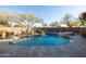 Backyard view of a private swimming pool with spa and lush desert landscaping at 8057 E Greythorn Dr, Gold Canyon, AZ 85118