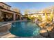 Backyard swimming pool featuring a jacuzzi with a rock waterfall element, and a covered patio at 8057 E Greythorn Dr, Gold Canyon, AZ 85118