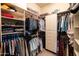 Functional walk-in closet with built-in shelving and rods for optimal storage and organization at 8057 E Greythorn Dr, Gold Canyon, AZ 85118