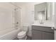Clean bathroom featuring shower-tub combo, grey vanity and modern fixtures at 8255 N 22Nd Dr, Phoenix, AZ 85021