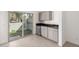 Open living space featuring built-in cabinets, stainless steel refrigerator, and sliding glass doors at 8255 N 22Nd Dr, Phoenix, AZ 85021
