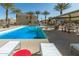 Community pool with palm trees, lounge chairs, and an inviting space for relaxing at 8255 N 22Nd Dr, Phoenix, AZ 85021