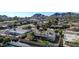 Aerial of neighborhood with mature palm trees, mountain views, and block wall fence at 9821 N 29Th Pl, Phoenix, AZ 85028