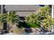 Backyard oasis with lush, green space surrounded by desert landscaping and palm trees at 9821 N 29Th Pl, Phoenix, AZ 85028