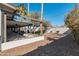 Backyard features a covered patio, lush trees, and rock landscape at 9821 N 29Th Pl, Phoenix, AZ 85028
