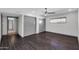 Bedroom with hardwood floors, fan, and gray sliding closet doors, illuminated by recessed lighting at 9821 N 29Th Pl, Phoenix, AZ 85028