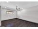 Bright bedroom featuring hardwood floors, a ceiling fan, and a window with natural light at 9821 N 29Th Pl, Phoenix, AZ 85028