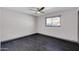 Bedroom features dark wood-look tile floors, ceiling fan, and a window at 9821 N 29Th Pl, Phoenix, AZ 85028