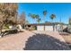 Stunning home exterior featuring a brick driveway and desert landscaping with lush green trees at 9821 N 29Th Pl, Phoenix, AZ 85028