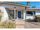 A close up of the front entrance with a modern blue door and desert landscaping at 9821 N 29Th Pl, Phoenix, AZ 85028