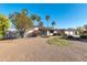 Charming front yard with desert landscaping, mature trees, and vibrant flowering bushes at 9821 N 29Th Pl, Phoenix, AZ 85028
