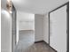 Hallway leads to an open living space beyond a doorway and features a modern light fixture at 9821 N 29Th Pl, Phoenix, AZ 85028