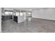 Open kitchen with a gray island, stainless steel appliances, and new stylish tile flooring at 9821 N 29Th Pl, Phoenix, AZ 85028