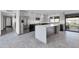 Open kitchen with stainless steel appliances, stylish island, and sliding glass doors to the backyard at 9821 N 29Th Pl, Phoenix, AZ 85028