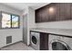 Laundry room with washer, dryer, and storage cabinets at 9821 N 29Th Pl, Phoenix, AZ 85028