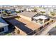 Aerial view of the backyard shows a large enclosed yard, covered patio and fire pit seating in a residential neighborhood at 10309 E Supernova Dr, Mesa, AZ 85212
