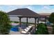 Lush backyard featuring a sparkling pool, covered lounge with seating, and mature landscaping, a perfect outdoor retreat at 10309 E Supernova Dr, Mesa, AZ 85212