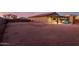 Large backyard with a covered patio, a cozy fire pit, and ample space for outdoor activities and entertaining at 10309 E Supernova Dr, Mesa, AZ 85212