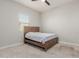 Cozy bedroom featuring a comfortable bed, carpeted floor, and natural light from a window at 10309 E Supernova Dr, Mesa, AZ 85212