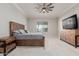 Comfortable bedroom featuring a wood bed frame, ceiling fan, and neutral decor at 10309 E Supernova Dr, Mesa, AZ 85212