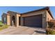 Well-maintained single-story home with neutral colors, desert landscaping, and an attached two-car garage at 10309 E Supernova Dr, Mesa, AZ 85212
