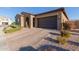 Well-maintained single-story home with neutral colors, desert landscaping, and an attached two-car garage at 10309 E Supernova Dr, Mesa, AZ 85212