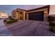 Well-maintained single-story home with neutral colors, desert landscaping, and an attached two-car garage at 10309 E Supernova Dr, Mesa, AZ 85212