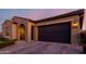 Well-maintained single-story home with neutral colors, desert landscaping, and an attached two-car garage at 10309 E Supernova Dr, Mesa, AZ 85212