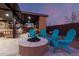 Relaxing fire pit area with Adirondack chairs under a covered patio for outdoor enjoyment at 10309 E Supernova Dr, Mesa, AZ 85212