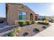 This single-story home boasts desert landscaping, an arched entry, and a two-car garage at 10309 E Supernova Dr, Mesa, AZ 85212