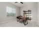 Home office with modern desk, shelving unit, and a large window for natural light at 10309 E Supernova Dr, Mesa, AZ 85212