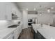 Gourmet kitchen boasts gas cooktop, white cabinets, and modern stainless appliances at 10309 E Supernova Dr, Mesa, AZ 85212