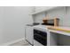 A laundry room boasts modern appliances, a folding table and shelving for optimal organization at 10309 E Supernova Dr, Mesa, AZ 85212