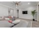 Bright living room featuring a large gray sofa, ceiling fan, and luxury vinyl floors at 10309 E Supernova Dr, Mesa, AZ 85212
