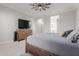 Comfortable main bedroom with a ceiling fan and a rustic wood dresser and accents at 10309 E Supernova Dr, Mesa, AZ 85212