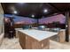 Covered outdoor kitchen with built-in grill, sink, and counter space for outdoor cooking at 10309 E Supernova Dr, Mesa, AZ 85212
