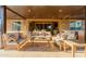 Covered patio featuring outdoor kitchen, multiple seating areas, and comfortable furnishings for luxurious outdoor living at 10309 E Supernova Dr, Mesa, AZ 85212