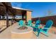 Cozy outdoor seating area with a gas firepit and Adirondack chairs perfect for relaxing and enjoying the backyard at 10309 E Supernova Dr, Mesa, AZ 85212