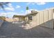 Spacious backyard featuring a covered patio and low maintenance desert landscaping at 10619 W Sells Dr, Phoenix, AZ 85037