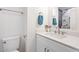 Modern bathroom with quartz countertops, a large mirror, and updated fixtures at 10619 W Sells Dr, Phoenix, AZ 85037